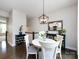 Charming dining area with a round table, white chairs, and a modern chandelier at 1839 Shumard Ln, Charlotte, NC 28205