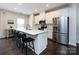 Modern kitchen featuring stainless steel appliances, a large island with seating, and white cabinets at 1839 Shumard Ln, Charlotte, NC 28205