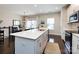 Bright, open-concept kitchen with a large island and seating area adjacent to the dining area at 1839 Shumard Ln, Charlotte, NC 28205