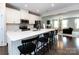 Open concept kitchen with a large island and barstool seating adjacent to a cozy living room at 1839 Shumard Ln, Charlotte, NC 28205