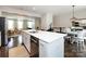Spacious kitchen island featuring white cabinets and an undermount sink, open to the living and dining areas at 1839 Shumard Ln, Charlotte, NC 28205
