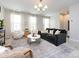 Cozy living room featuring a comfortable sofa, plush armchairs, and soft natural light at 1839 Shumard Ln, Charlotte, NC 28205