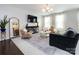 Bright living room with a TV, stylish furniture, and elegant hardwood floors at 1839 Shumard Ln, Charlotte, NC 28205