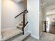 Carpeted staircase with stained wood handrail leads to the upper level, enhancing the home's appeal at 1839 Shumard Ln, Charlotte, NC 28205