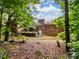 A brick house is shown from the backyard, surrounded by trees at 1878 Pl Propst Rd, Maiden, NC 28650