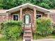 Charming brick home featuring a front door with decorative accents, lush shrubbery, and inviting curb appeal at 1878 Pl Propst Rd, Maiden, NC 28650