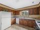 Traditional kitchen features wood cabinets, granite countertops, and modern appliances at 1878 Pl Propst Rd, Maiden, NC 28650