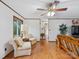 Cozy living room featuring hardwood floors, seating, and ample natural light creating a warm, inviting atmosphere at 1878 Pl Propst Rd, Maiden, NC 28650