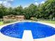 Refreshing in-ground pool with diving board, set against a backdrop of lush greenery at 1878 Pl Propst Rd, Maiden, NC 28650