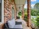 Inviting brick porch area featuring comfortable seating, a view of the backyard, and access to a refreshing pool at 1878 Pl Propst Rd, Maiden, NC 28650