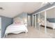 Bedroom featuring neutral walls, carpeted floor, closet with mirrored doors, and an attic ceiling at 2018 Rosewater Ln, Indian Trail, NC 28079