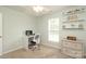 Bedroom featuring neutral walls, carpeted floor, ceiling fan, and shelves above a two-drawer chest at 2018 Rosewater Ln, Indian Trail, NC 28079