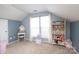 Bedroom featuring neutral walls, carpeted floor, and a small vanity near a bright window at 2018 Rosewater Ln, Indian Trail, NC 28079
