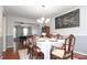 Elegant dining room with a set table, chandelier, and view into game room at 2018 Rosewater Ln, Indian Trail, NC 28079