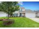 Charming two-story home features green shutters, a front yard and a two car garage at 2018 Rosewater Ln, Indian Trail, NC 28079