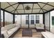 The gazebo interior has comfortable seating, a wooden deck, and a ceiling fan at 2018 Rosewater Ln, Indian Trail, NC 28079