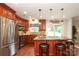 Updated kitchen boasts stainless appliances, granite countertops, and a center island with barstool seating for casual dining at 2018 Rosewater Ln, Indian Trail, NC 28079
