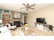 Inviting living room featuring a fireplace, built-in bookshelves, and a ceiling fan, creating a warm and cozy atmosphere at 2018 Rosewater Ln, Indian Trail, NC 28079
