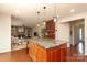 Open concept living space features a kitchen island, barstool seating, and seamless flow into the living area with fireplace at 2018 Rosewater Ln, Indian Trail, NC 28079