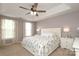 Serene main bedroom with a tray ceiling, large windows, and neutral decor, creating a peaceful retreat at 2018 Rosewater Ln, Indian Trail, NC 28079