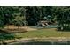 Community playground featuring swings and slides surrounded by lush greenery at 2018 Rosewater Ln, Indian Trail, NC 28079