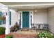 Cozy porch with outdoor seating, potted plants, and a welcoming entrance featuring a teal door at 2018 Rosewater Ln, Indian Trail, NC 28079