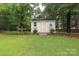 Storage shed exterior features decorative flower boxes and a wood chip border at 2018 Rosewater Ln, Indian Trail, NC 28079