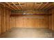 A utilitarian storage space with unfinished wood, overhead storage and a wood plank floor at 2018 Rosewater Ln, Indian Trail, NC 28079