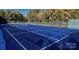 Well-maintained blue tennis courts surrounded by lush greenery create an active community space at 2018 Rosewater Ln, Indian Trail, NC 28079