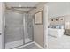 Modern bathroom featuring a tiled shower with a glass door, next to primary bedroom at 2024 Bramble Hedge Rd # 3275, Indian Trail, NC 28079