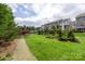 Landscaped backyard with a walking path and manicured greenery at 2653 Shenandoah Ave, Charlotte, NC 28205