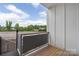 Outdoor balcony with wood flooring and metal railings offers space for relaxation and outdoor dining at 2653 Shenandoah Ave, Charlotte, NC 28205
