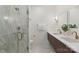 Modern bathroom boasts a walk-in shower, double vanity with gold fixtures, and marble accents at 2653 Shenandoah Ave, Charlotte, NC 28205