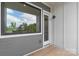 Modern home exterior featuring a porch, a large window, and stylish gray and white siding at 2653 Shenandoah Ave, Charlotte, NC 28205