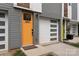 Close-up of a modern townhome with a bright orange door and a white garage door at 2653 Shenandoah Ave, Charlotte, NC 28205