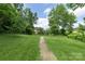 Scenic walking path through a lush green space with mature trees at 2653 Shenandoah Ave, Charlotte, NC 28205
