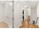 Hallway with storage, laundry closet, hardwood floors and natural light from stairway at 2653 Shenandoah Ave, Charlotte, NC 28205