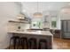 Modern kitchen with white countertops, island seating, stainless steel appliances, and stylish pendant lighting at 2653 Shenandoah Ave, Charlotte, NC 28205