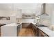 Open concept kitchen with stainless steel appliances, white countertops and cabinetry and hardwood floors at 2653 Shenandoah Ave, Charlotte, NC 28205