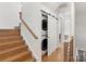 Stacked washer and dryer tucked away with sliding barn door, next to stairway at 2653 Shenandoah Ave, Charlotte, NC 28205