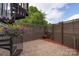 A private outdoor patio features brick pavers, a spiral staircase and a wooden fence, creating a relaxing and secluded space at 2653 Shenandoah Ave, Charlotte, NC 28205