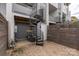 Charming private patio features brick pavers, a decorative spiral staircase, and a privacy fence with access to upper levels at 2653 Shenandoah Ave, Charlotte, NC 28205