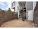 Private patio with brick pavers, spiral staircase, and wooden fence, providing a perfect blend of privacy and outdoor charm at 2653 Shenandoah Ave, Charlotte, NC 28205