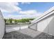 Relaxing rooftop deck showcases a modern railing with city views and patterned pavers at 2653 Shenandoah Ave, Charlotte, NC 28205