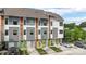 View of newly constructed townhomes featuring modern architecture, individual garages, and colorful front doors at 2653 Shenandoah Ave, Charlotte, NC 28205