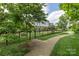 Well-maintained walking path bordered by lush greenery and a fence at 2653 Shenandoah Ave, Charlotte, NC 28205