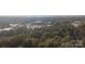 Scenic aerial shot showcases lush treetop landscape with city views beyond at 2701 Ravencroft Dr, Charlotte, NC 28208