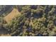Aerial view of the neighborhood and surrounding woods, including playground and parking at 2701 Ravencroft Dr, Charlotte, NC 28208