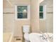 Bright bathroom features modern fixtures, tiled walls, and natural light from the window at 2701 Ravencroft Dr, Charlotte, NC 28208