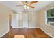 Bedroom with hardwood floors, a ceiling fan, and ample natural light from the window at 2701 Ravencroft Dr, Charlotte, NC 28208